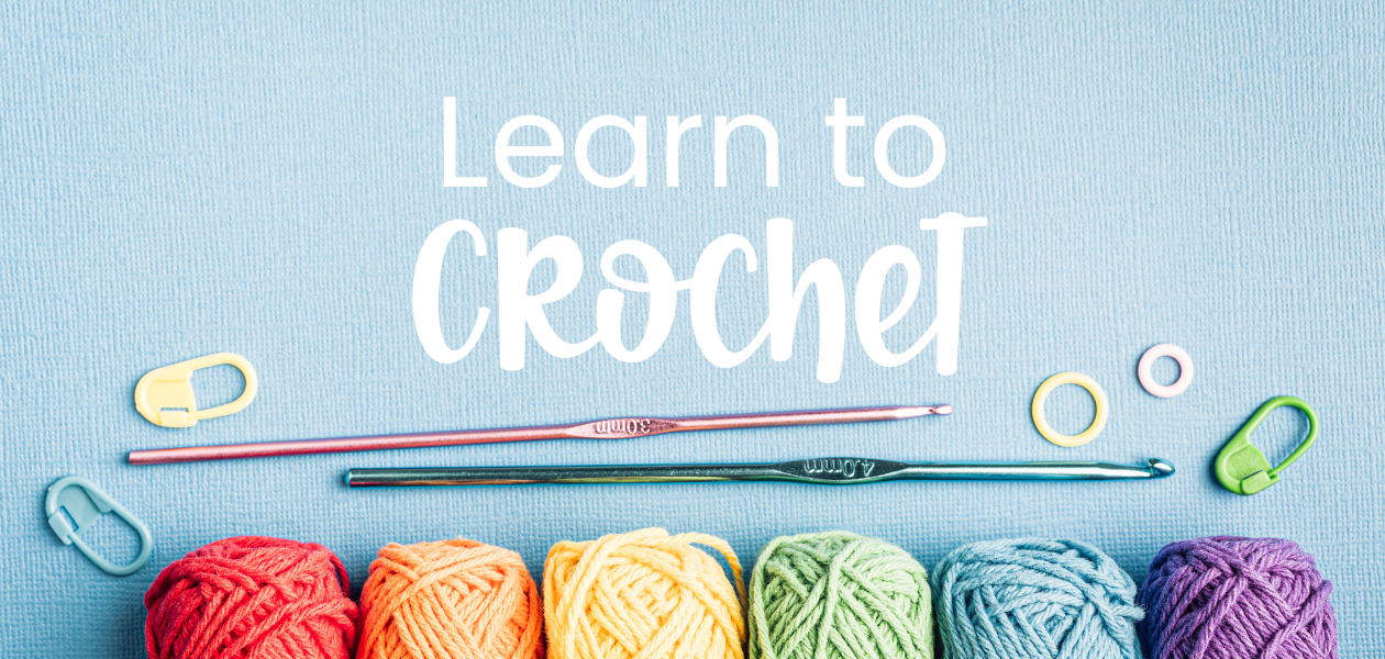 Learn to Crochet — crochet hooks, stitch markers and rainbow yarn balls on a blue background
